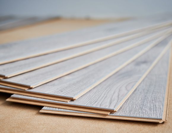 Samples of laminate panels with pattern and wood texture for flooring and interior design. Wooden flooring boards for home renovation, construction works and interior architecture.
