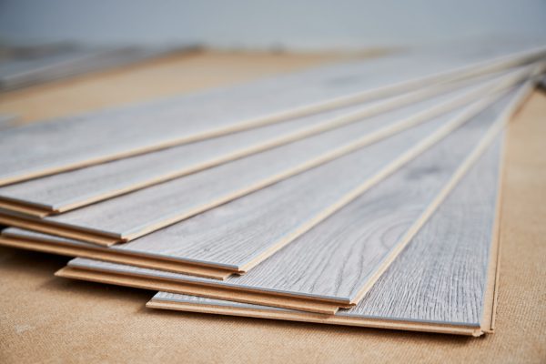 Samples of laminate panels with pattern and wood texture for flooring and interior design. Wooden flooring boards for home renovation, construction works and interior architecture.
